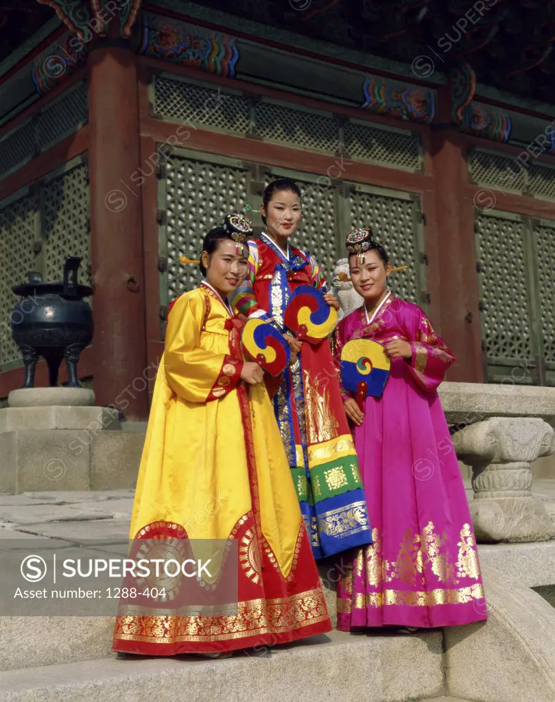 Portrait of three young women dressed in traditional clothing, South Korea