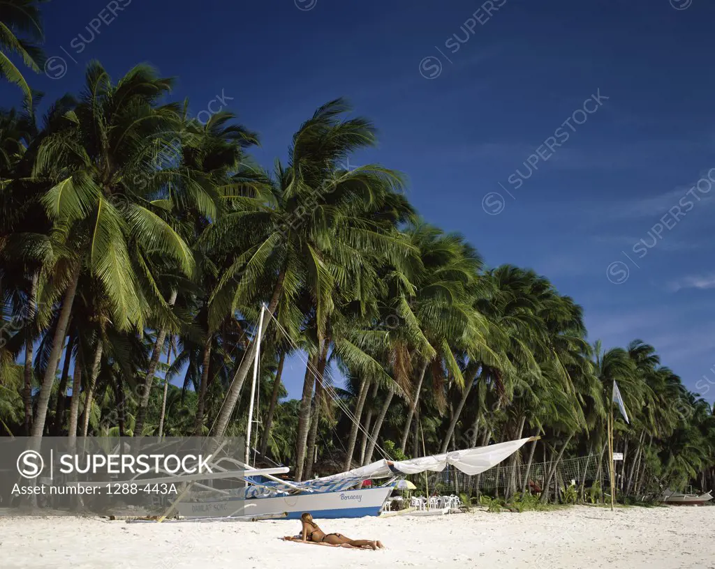 Woman lying on the beach, Boracay, Philippines