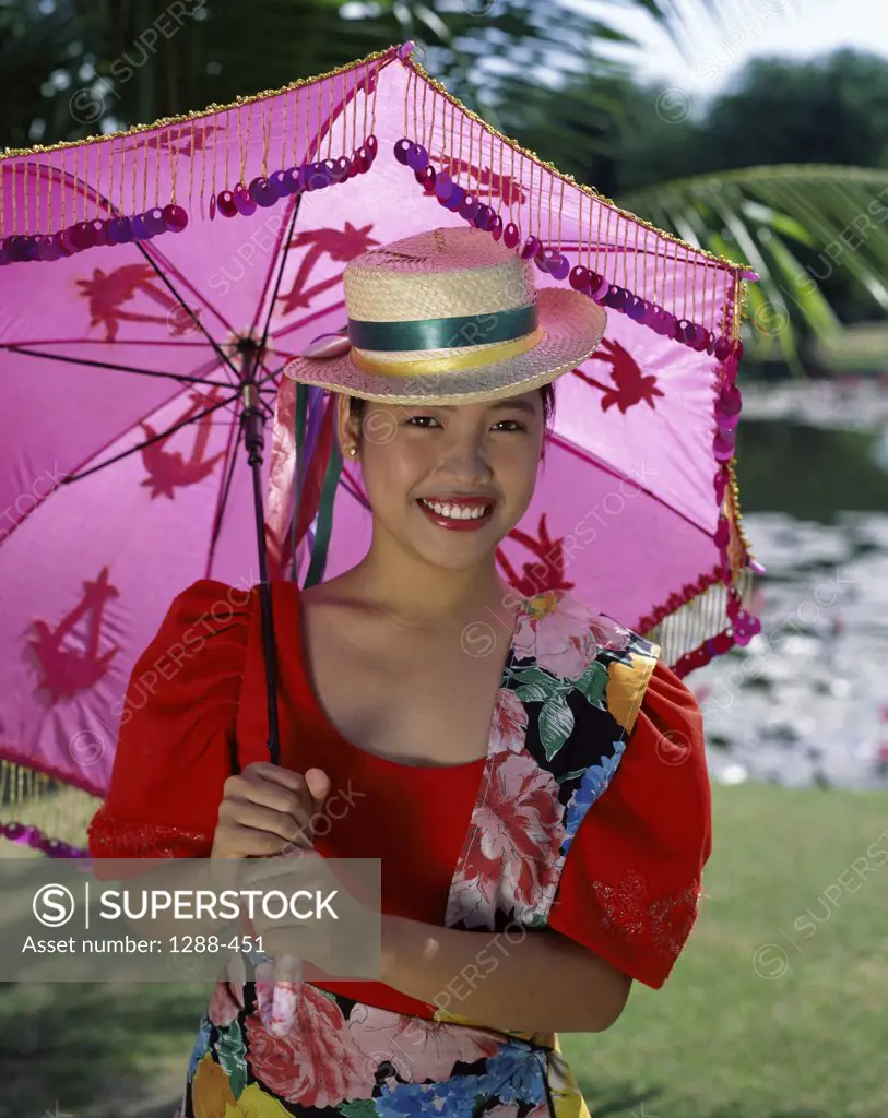 Portrait of a young woman holding a parasol, Philippines