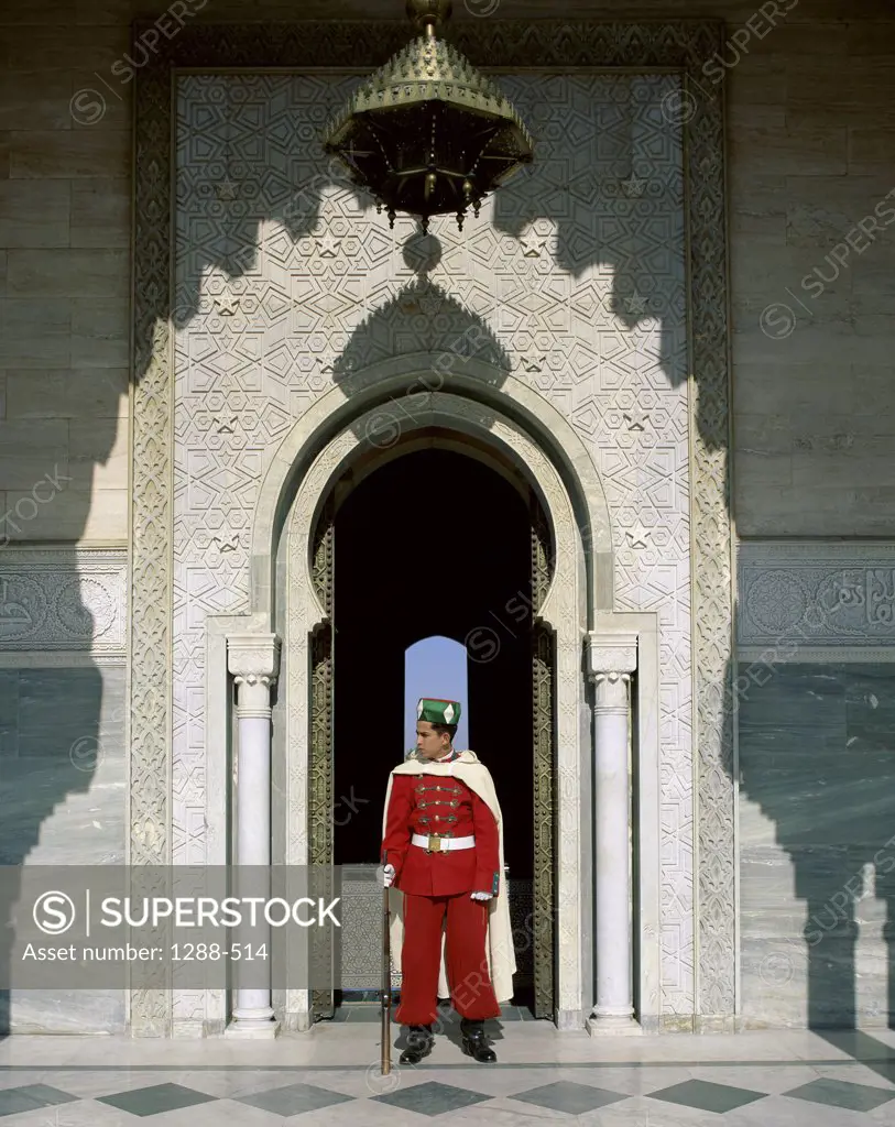Guard standing in front of the gate of a mausoleum, Mohammed V Mausoleum, Rabat, Morocco