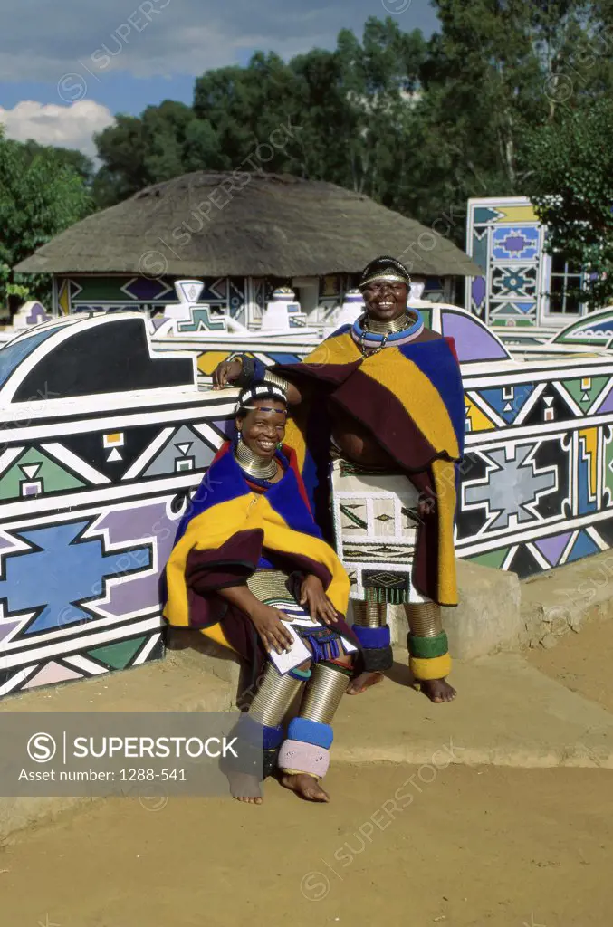 Two mid adult women wearing costumes, Ndebele Village, Transvaal, South Africa