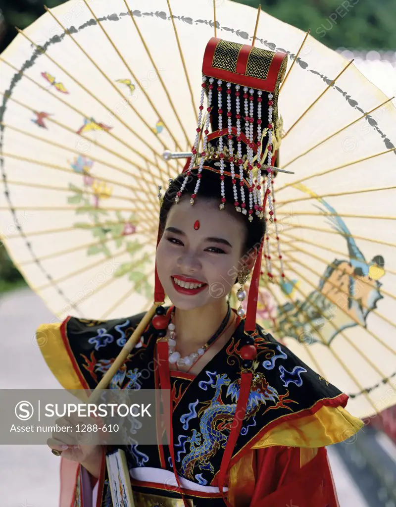 Portrait of a young woman holding a parasol, China
