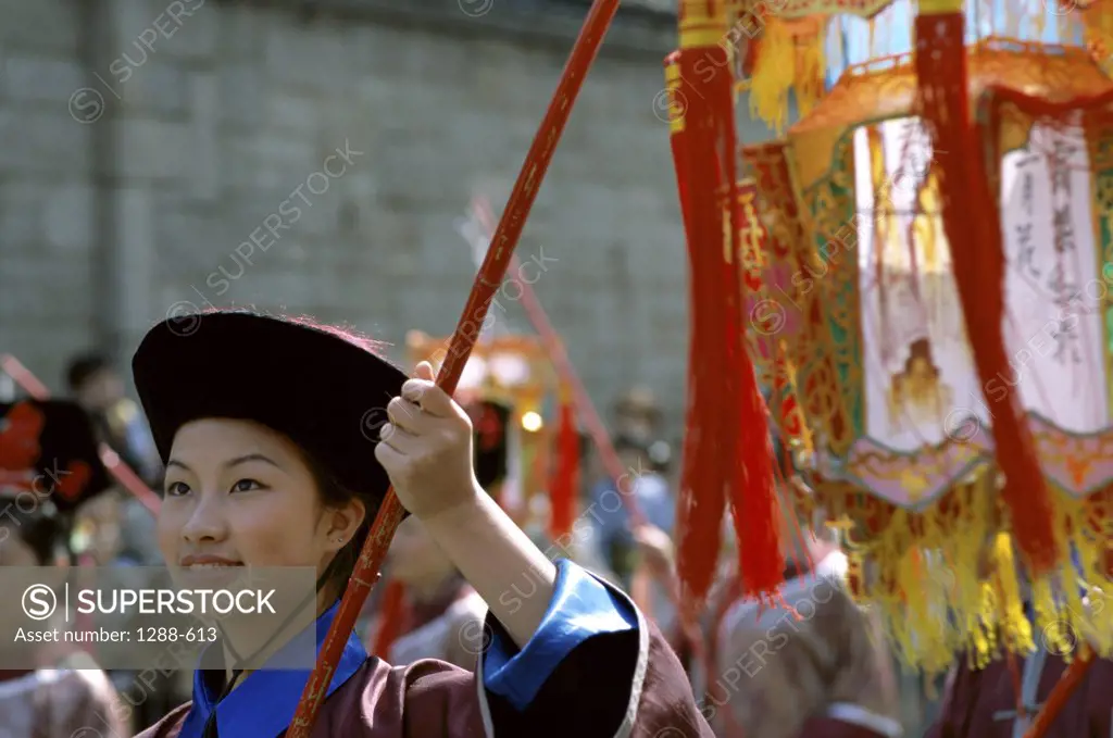 Young woman wearing a traditional clothing in a parade, China