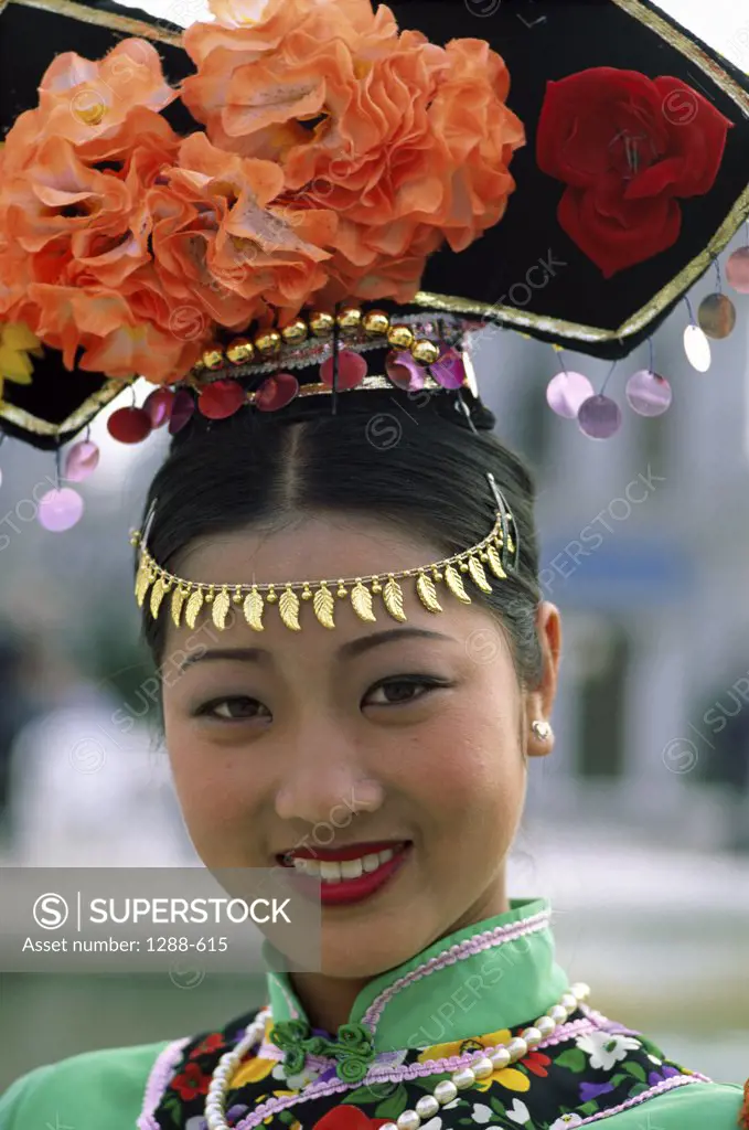 Portrait of a young woman wearing traditional clothing, China