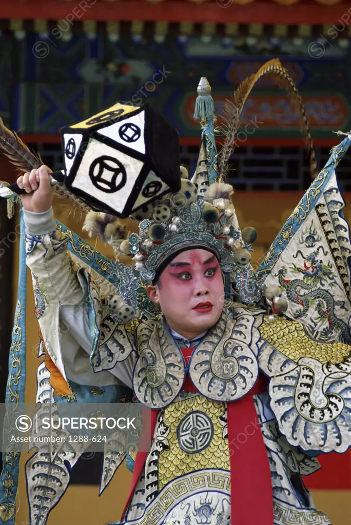 Male opera performer performing on a stage, China