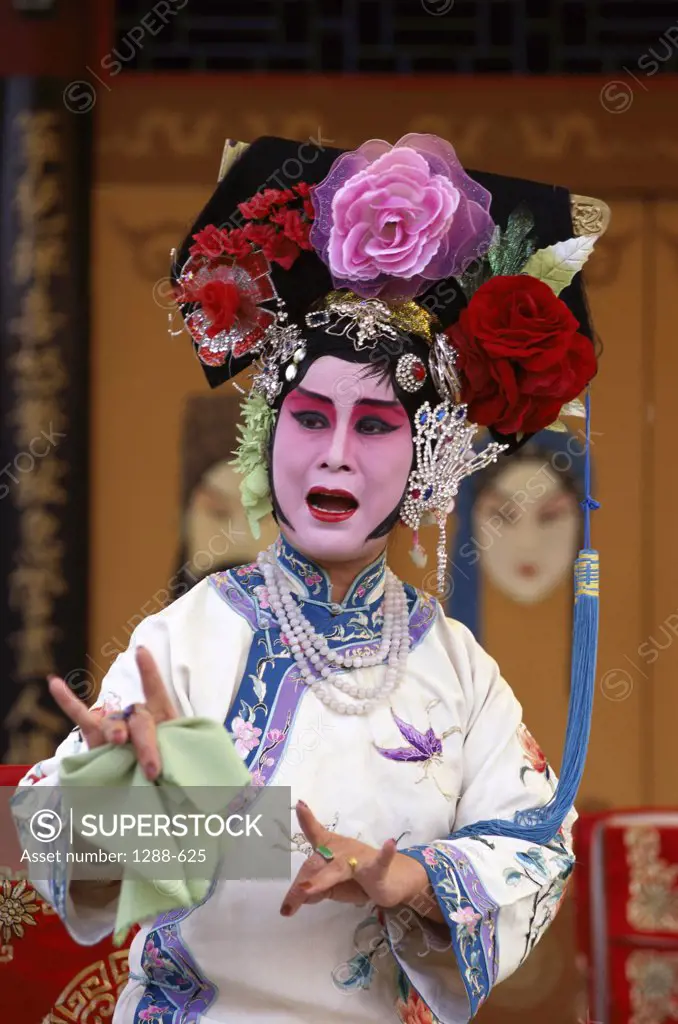 Female opera performer performing on a stage, China