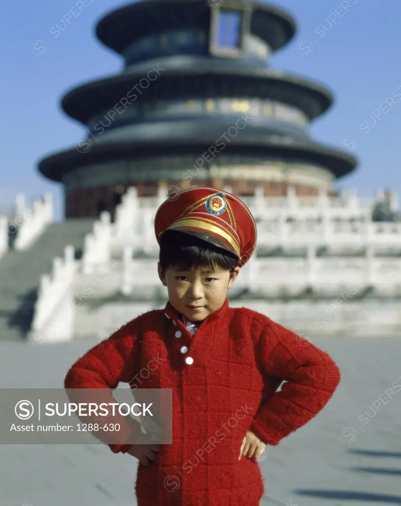 Portrait of a boy standing in front of a temple, Temple of Heaven, Beijing, China
