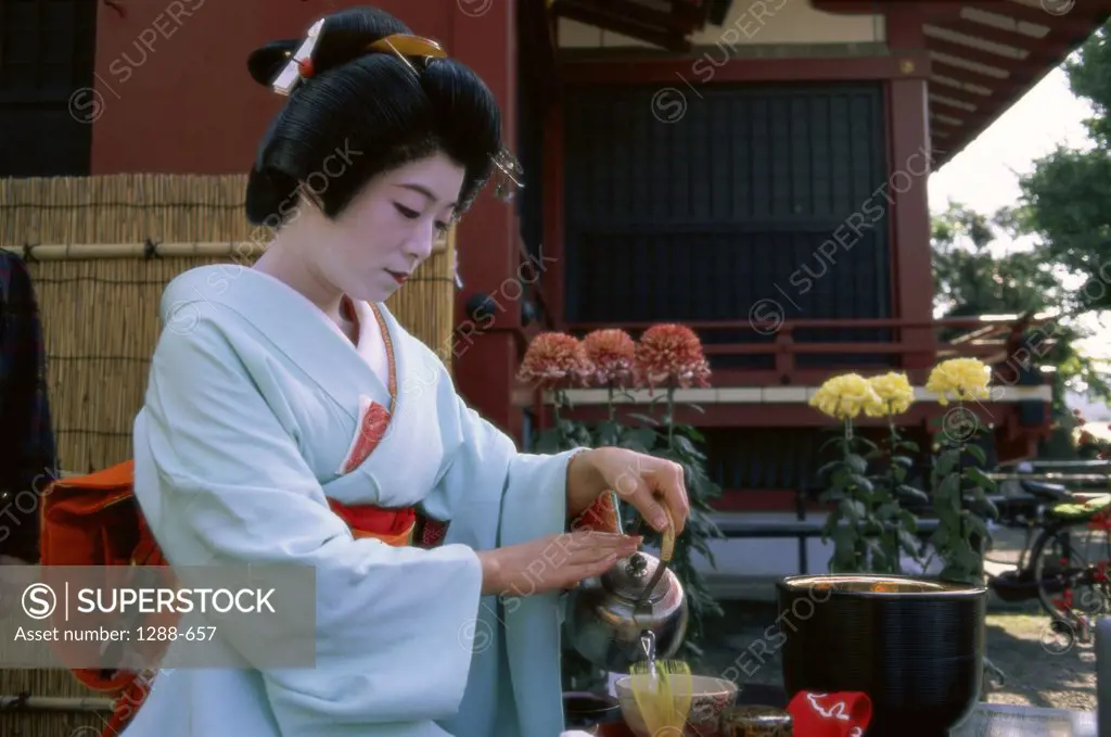 Young woman in kimono pouring tea in a bowl, Tea Ceremony, Japan