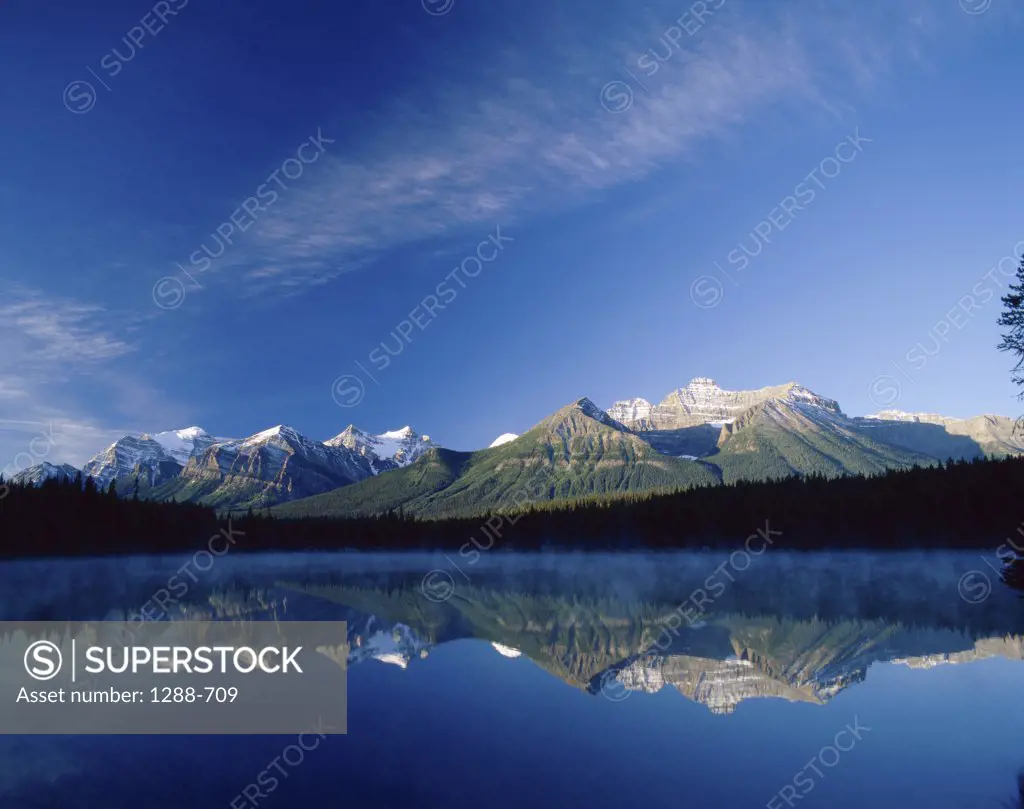 Reflection of mountains in water, Lake Herbert, Banff National Park, Alberta, Canada