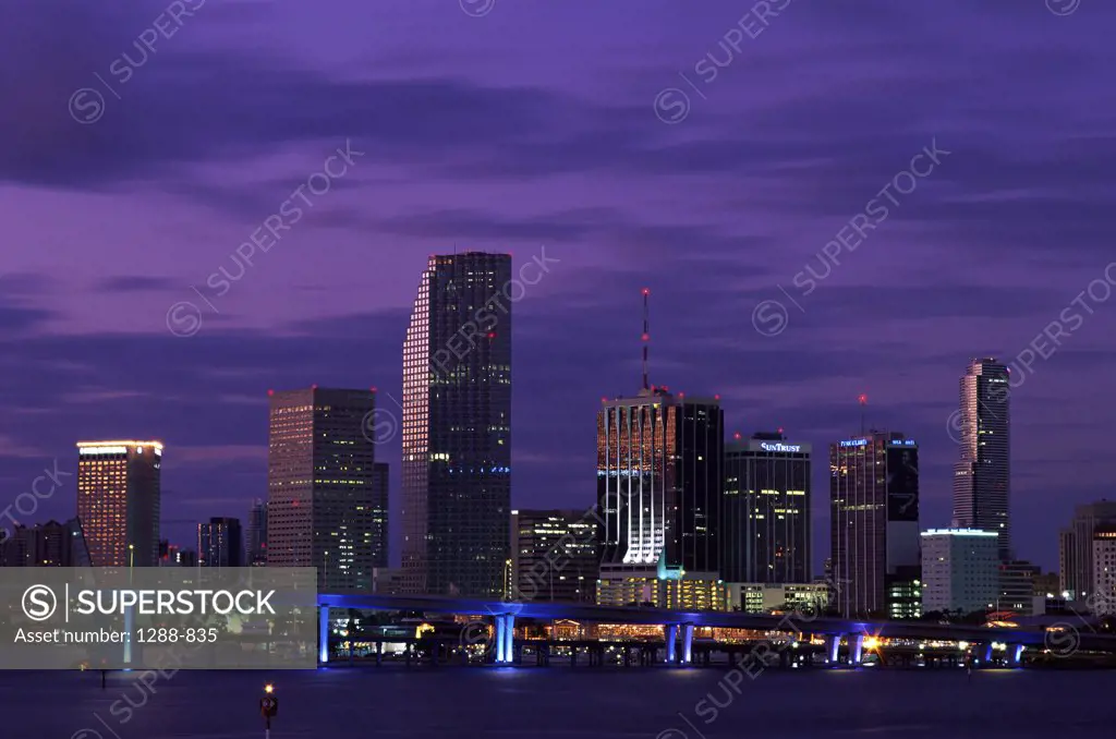 Buildings on the waterfront lit up at dusk, Miami, Florida, USA