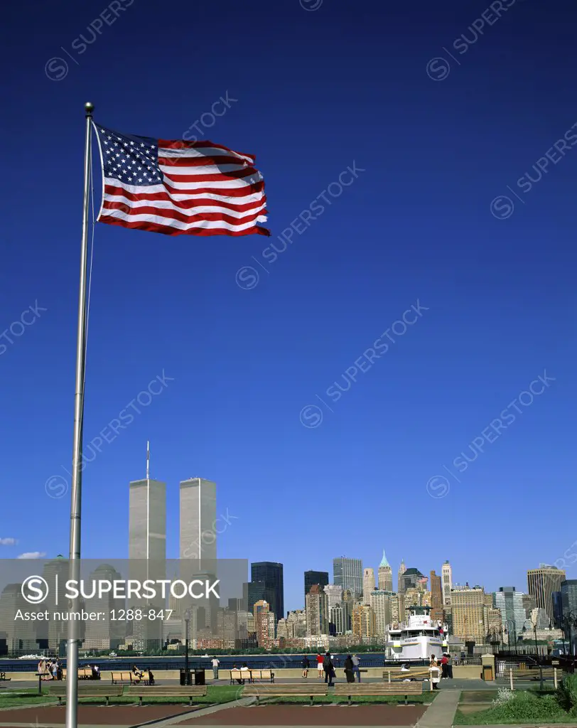 Flag in front of buildings, New York City, New York, USA