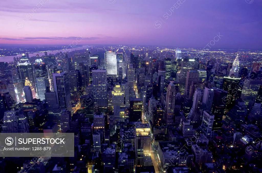 Aerial view of a city lit up at dusk, New York City, New York, USA