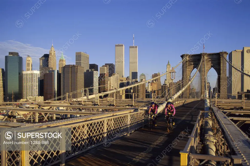 Two people cycling on a bridge, Brooklyn Bridge, New York City, New York, USA