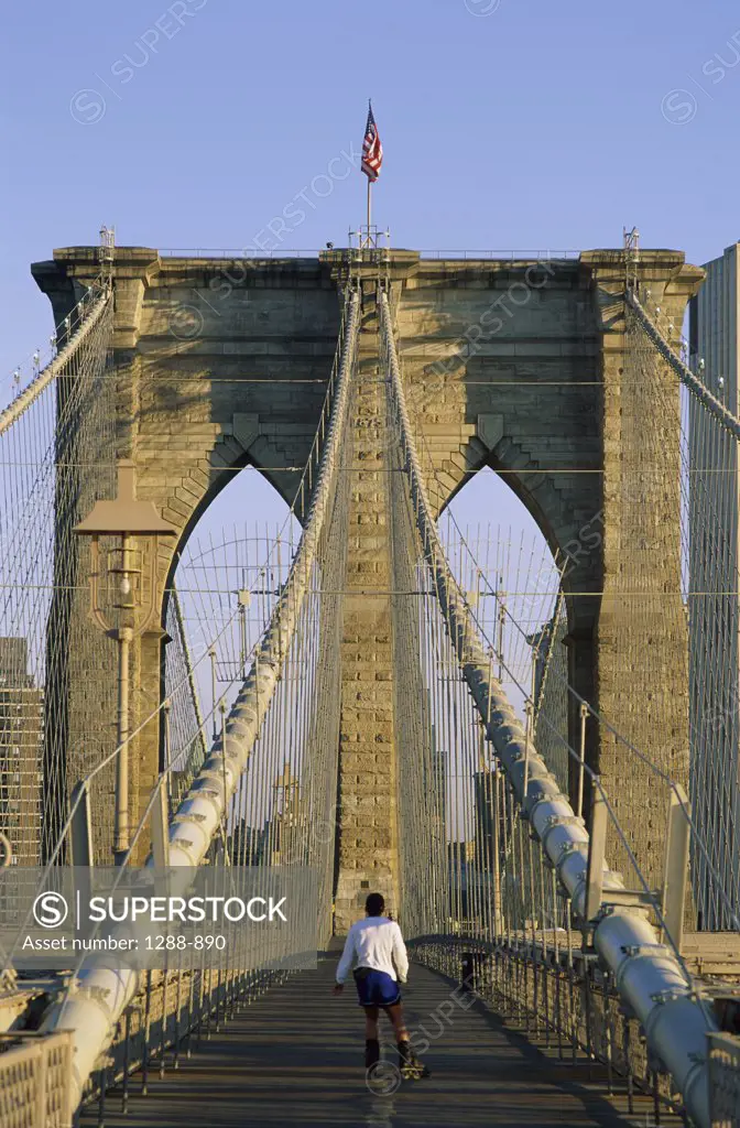 Rear view of a person rollerblading on a bridge, Brooklyn bridge, New York City, New York, USA