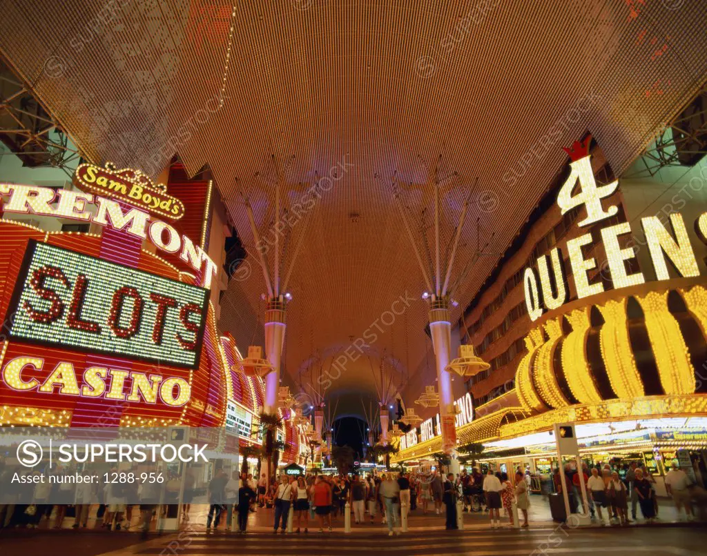Tourists at a casino lit up at night, Fremont Street, Las Vegas, Nevada, USA