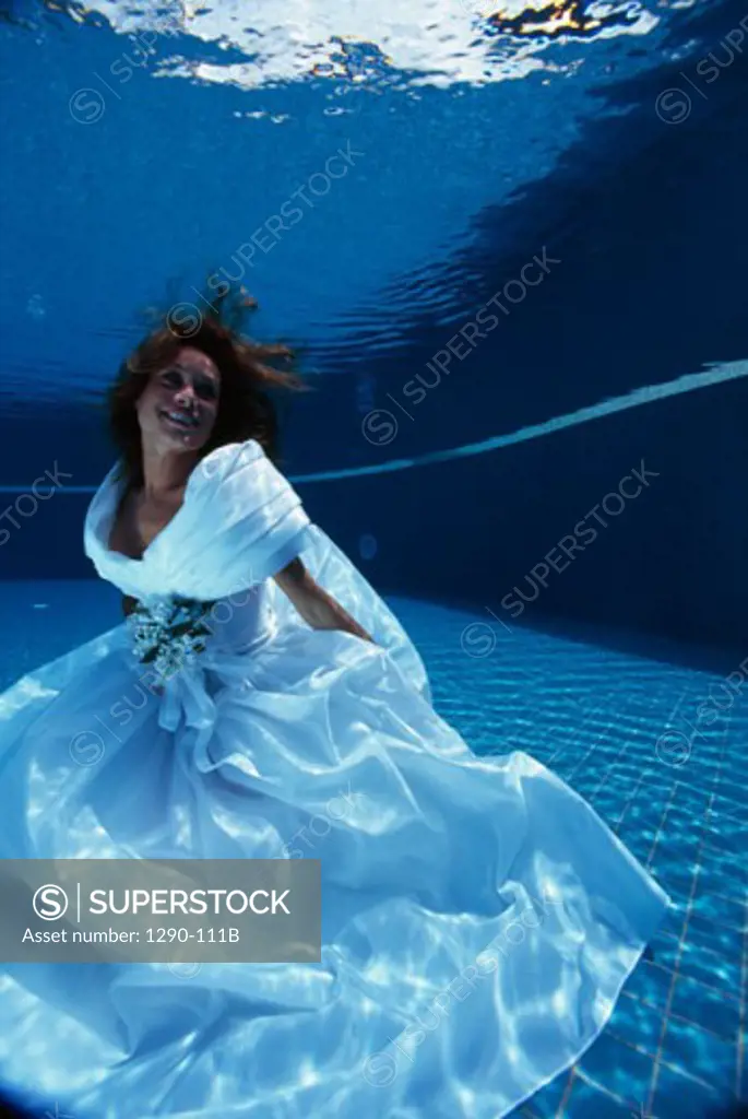 Bride swimming underwater