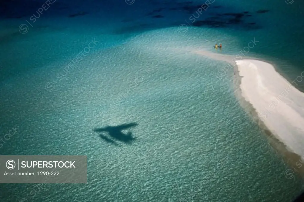 Aerial view of the shadow of a seaplane on water