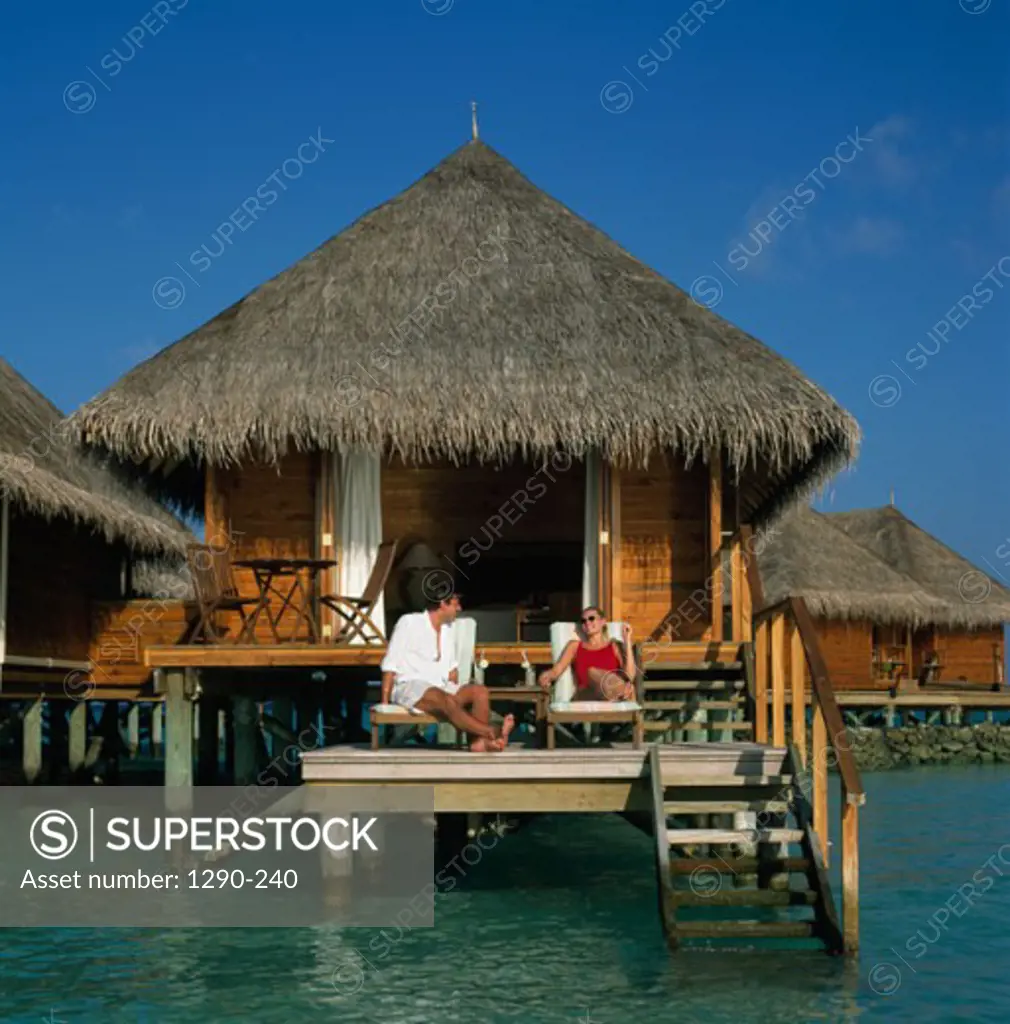 Young couple on the deck of a bungalow