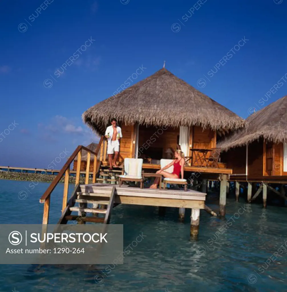 Young couple on the deck of a bungalow