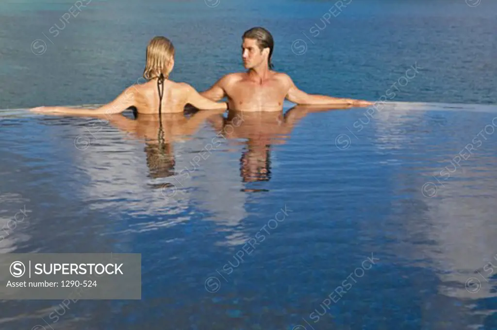 Young couple in a swimming pool, Banyan Tree Hotel, Anse Intendance, Mahe Island, Seychelles
