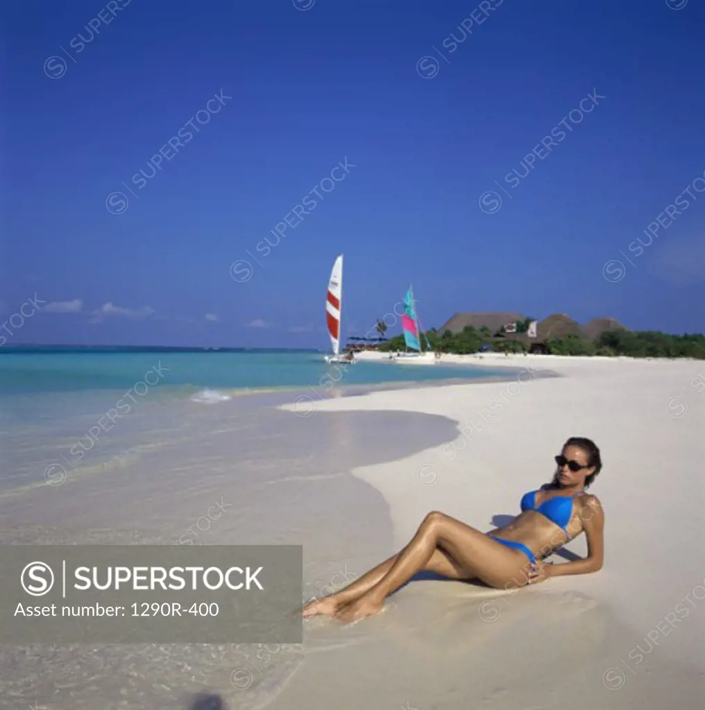 Young woman lying on the beach