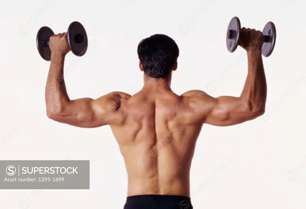 Rear view of a man holding up dumbbells