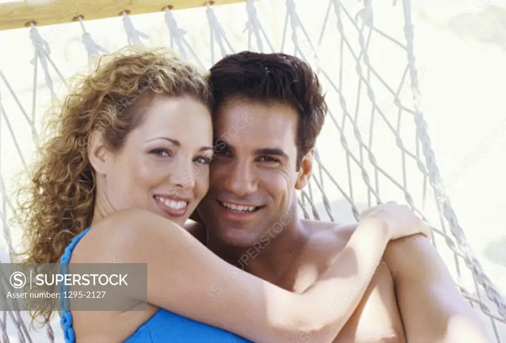 Portrait of a young couple lying in a hammock