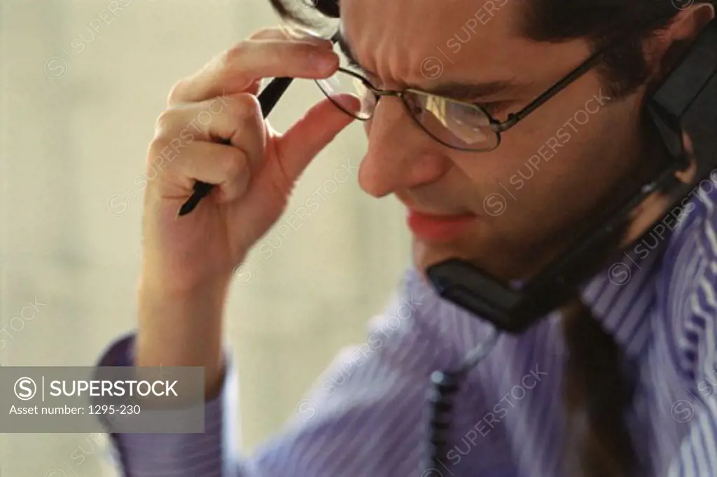 Businessman talking on landline telephone
