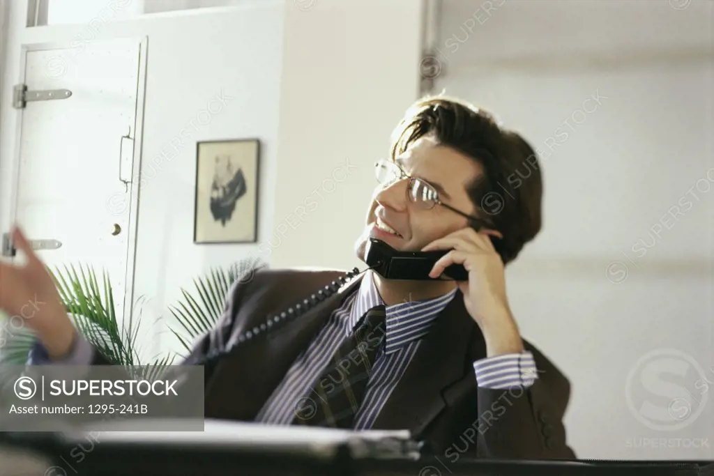 Businessman talking on a landline telephone