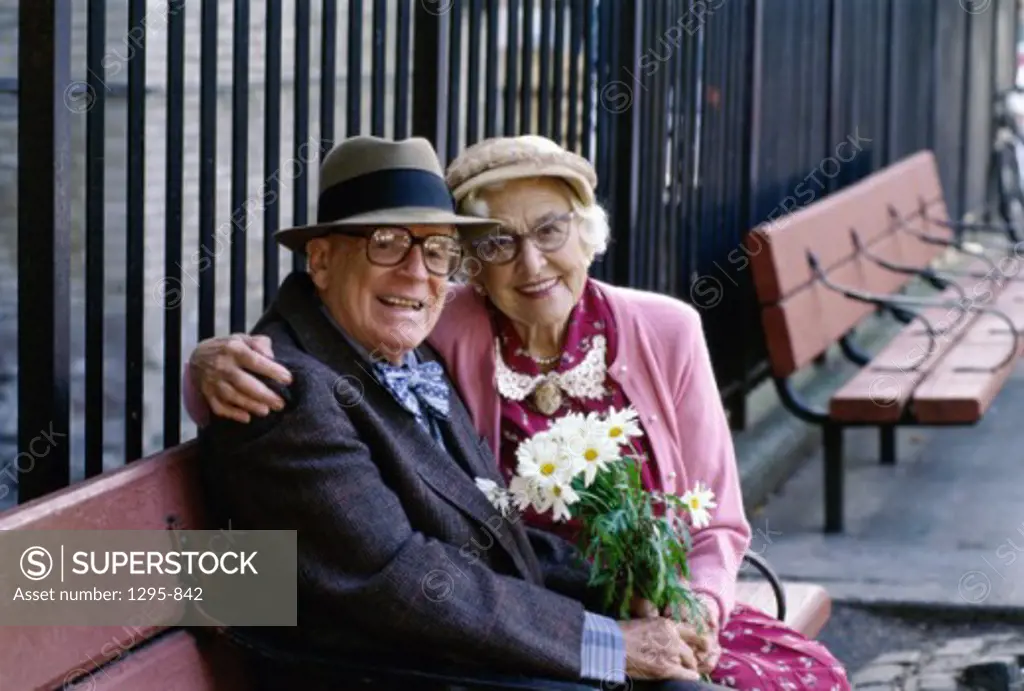 Portrait of a senior couple sitting together on a bench