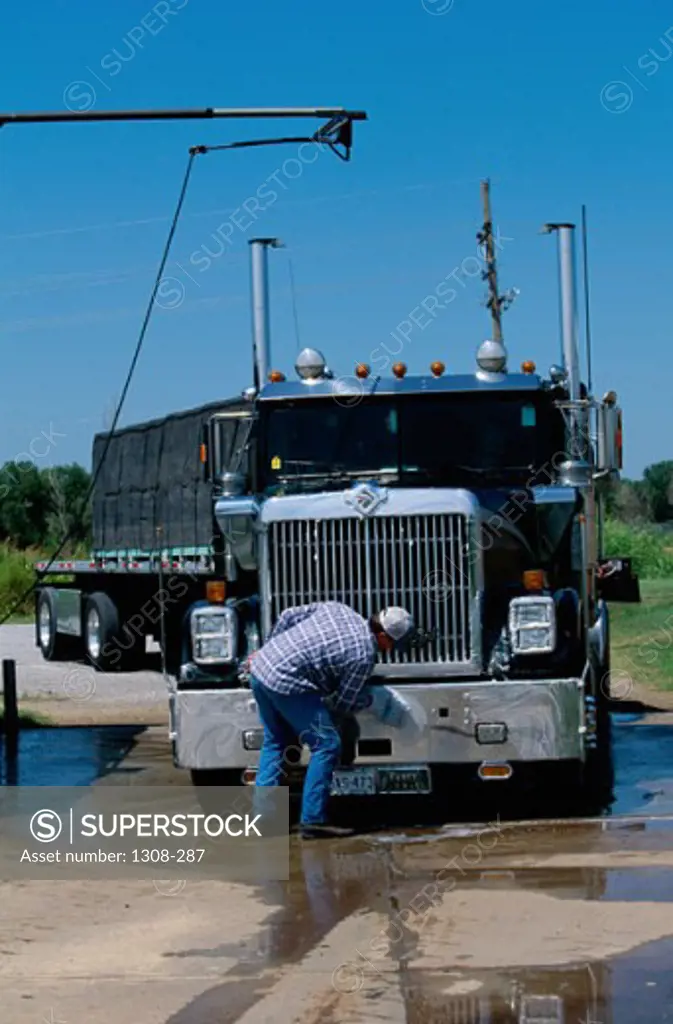 Man cleaning a truck in Barber, Kansas, USA