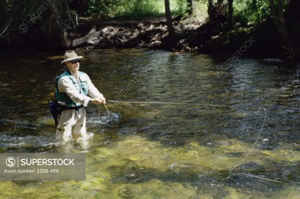 High angle view of a mid adult man fishing in a river