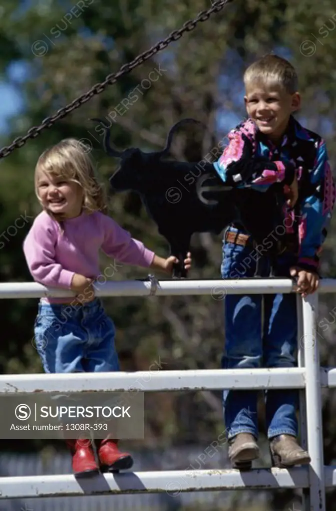 Boy and girl standing against a railing