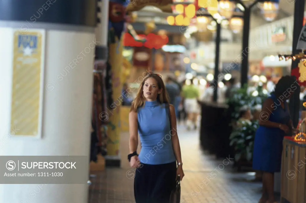 Young woman walking in a shopping mall