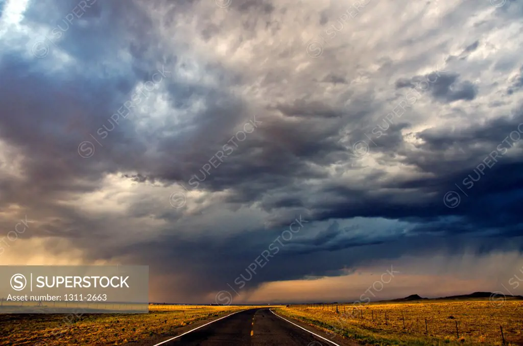 Highway under the cloudy sky at sunset, New Mexico, USA