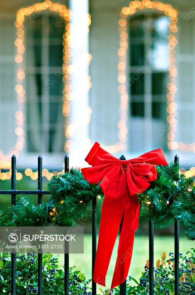 Red Christmas bow on fence, French Quarter, New Orleans, Louisiana, USA