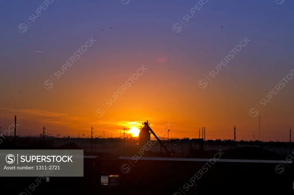 Oil refinery along the Industrial Canal in New Orleans East, Louisiana at sunset.