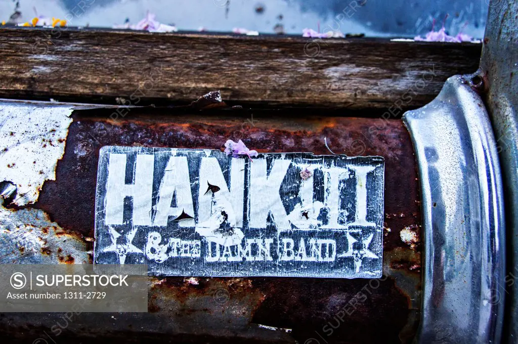 Old Hank Williams bumper sticker on a rusty bumper sticker