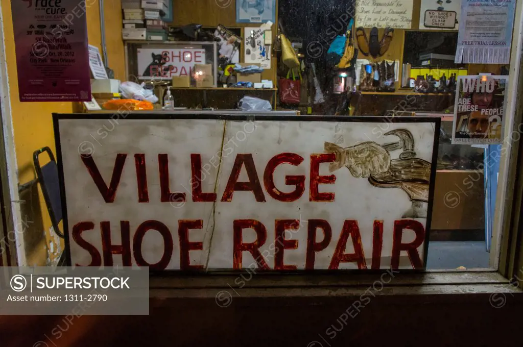 Old school sign for a mom and pop business, a shoe repair shop.