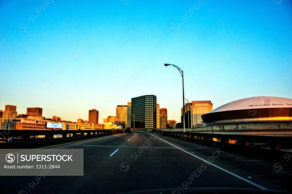 A sunny evening and the New Orleans skyline as seen from Interstate 10 heading east.