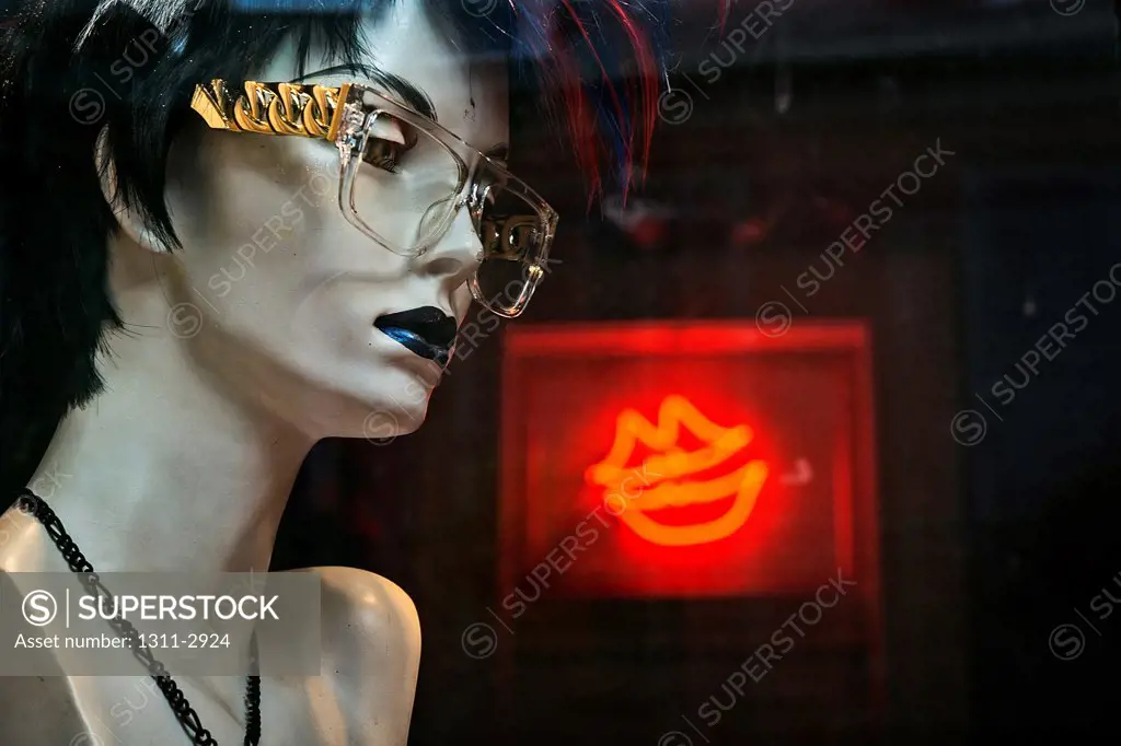 Glasses wearing mannequin and red lips.