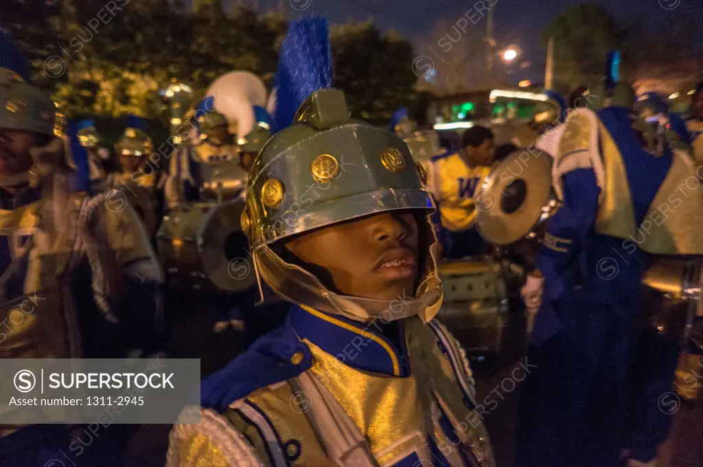 Marching band member of the St. Augustine Marching 100 lines up as he readies for a Mardi Gras parade.