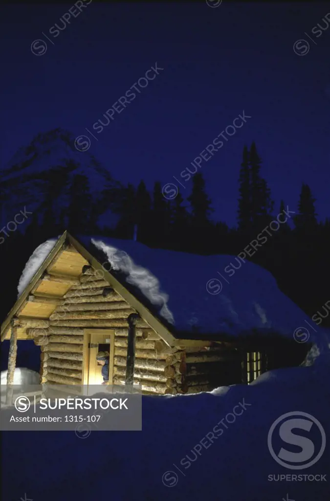 Snow on the roof of a log cabin