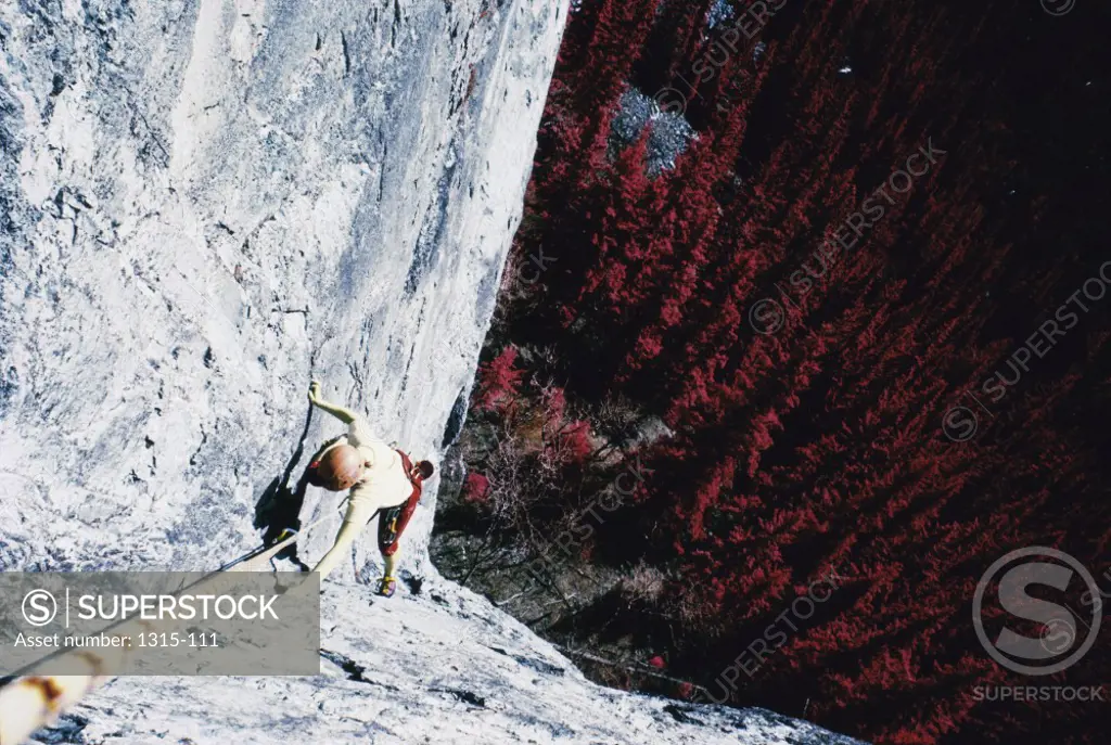 High angle view of a woman climbing a rock face, Alberta, Canada