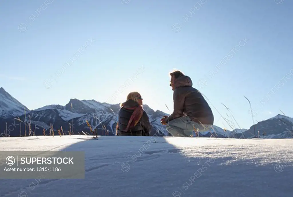 Mature couple enjoying in snow, Alberta, Canada