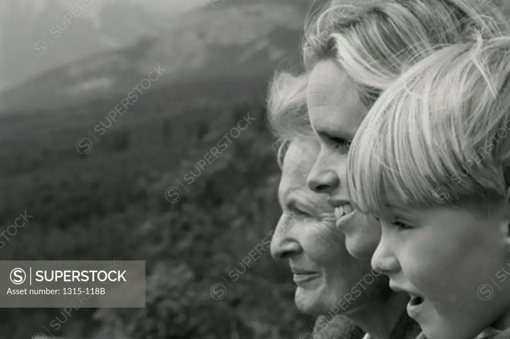 Side profile of a grandmother smiling with her daughter and grandson