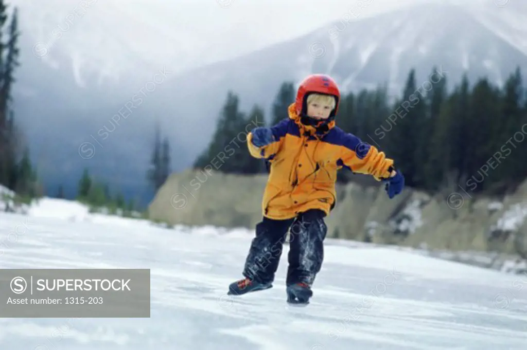 Boy ice skating, Banff, Alberta, Canada