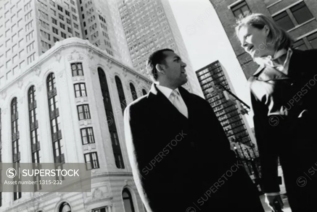 Low angle view of a businessman and a businesswoman talking to each other