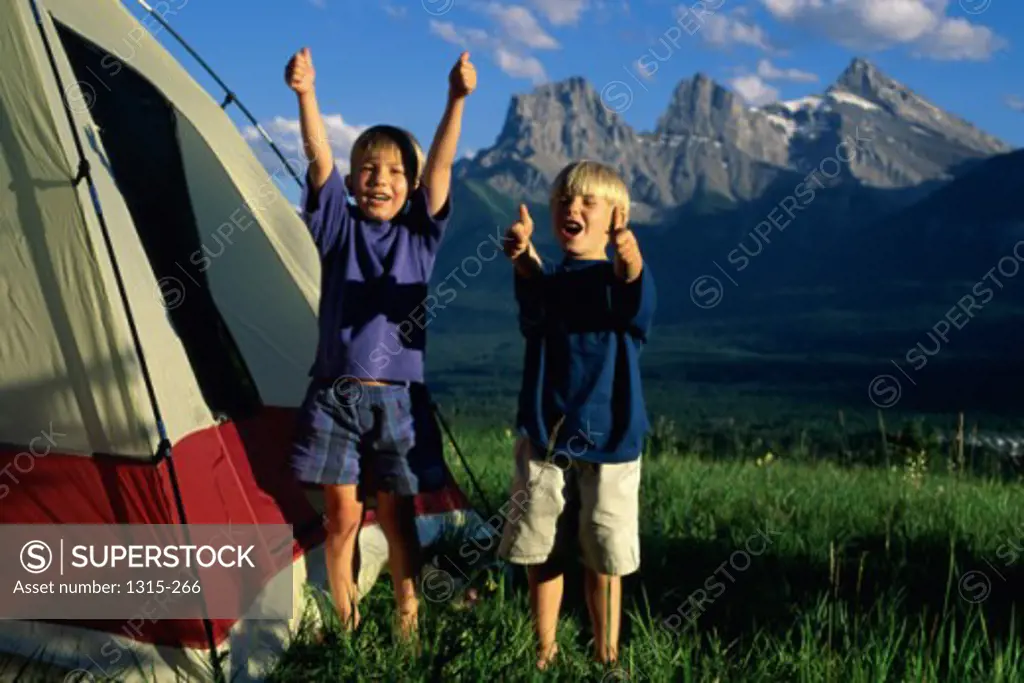 Portrait of two brothers playing outside a tent, Banff National Park, Alberta, Canada