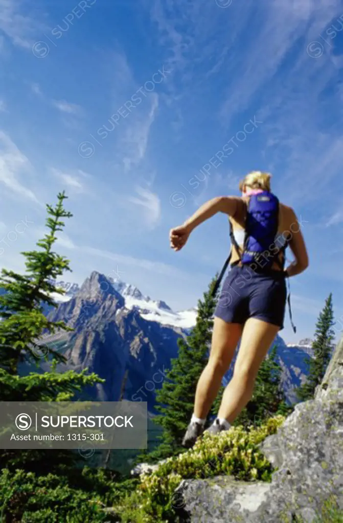 Rear view of a young woman hiking, Banff, Alberta, Canada